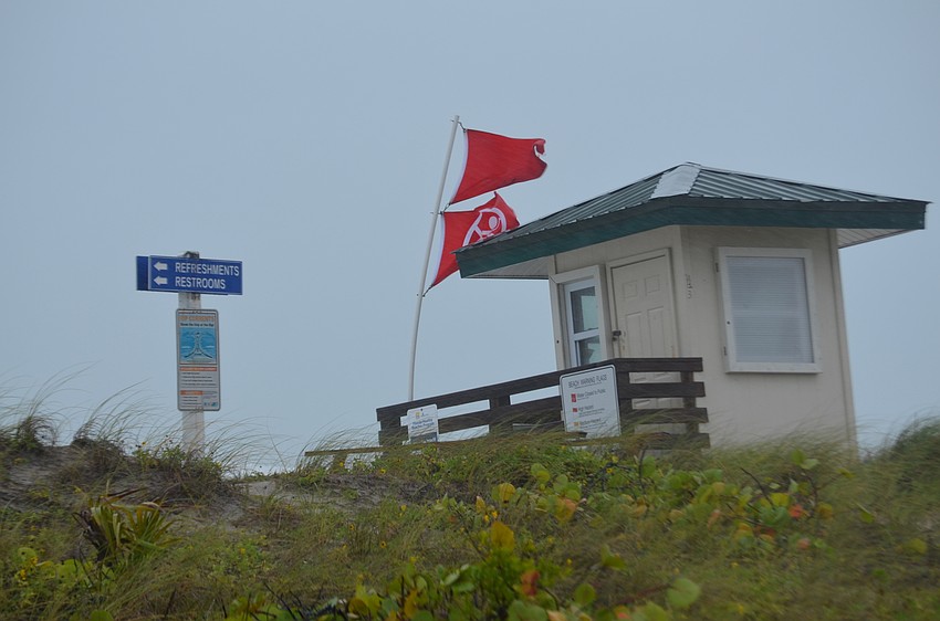 Wind whips a lifeguard stand at Lido Beach during Tropical Storm Colin.