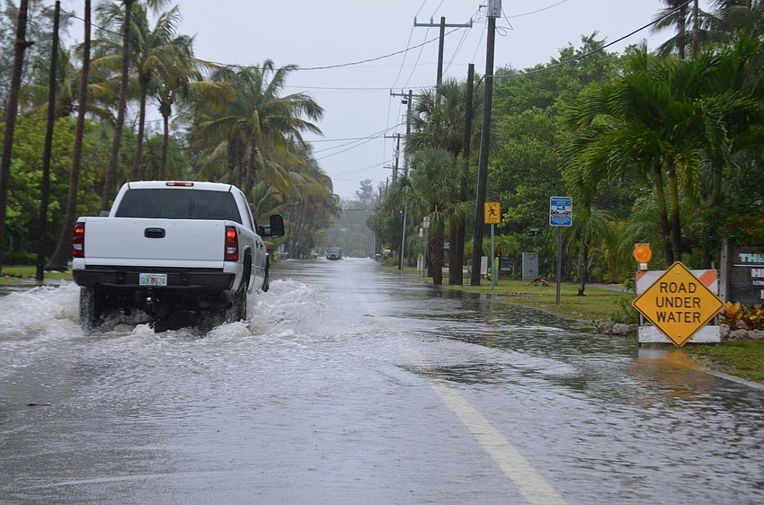 Vehicles struggled to navigate Broadway Street during Tropical Storm Colin.