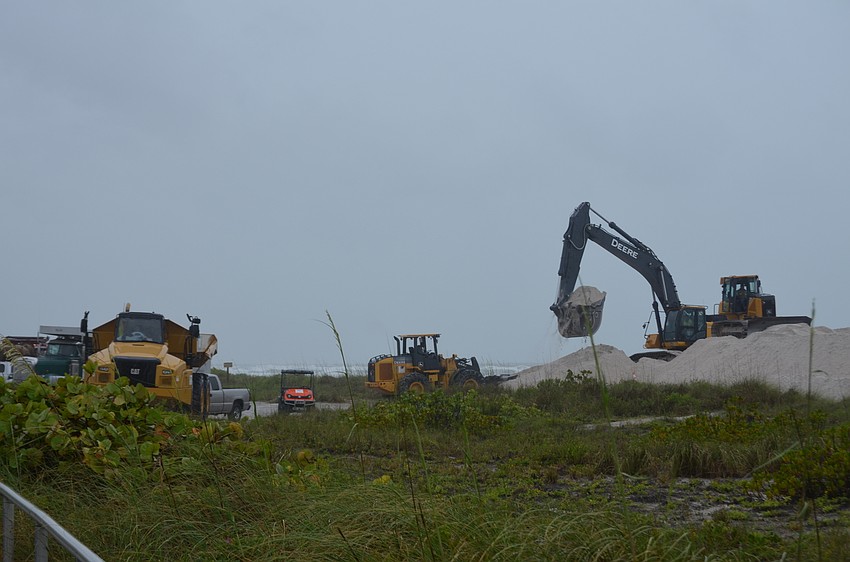 Despite the weather, detractors continued working on the truck haul renourishment.