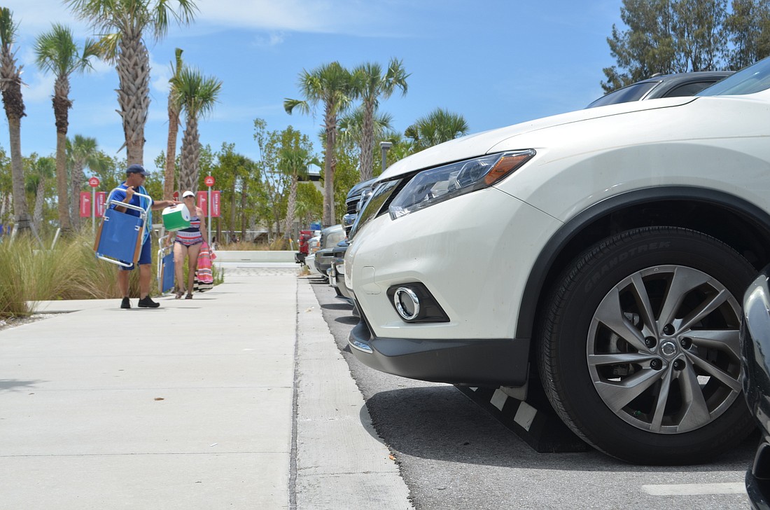 Two visitors try to find their car in the Siesta Key Beach public parking lot on Saturday, June 4. Tourism rates as measured by tourism development tax revenues have continued to increase since fiscal year 2014.