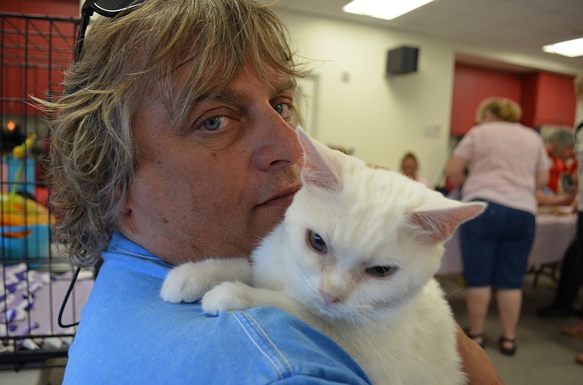 Chris Adamo and his doughnut named cat Boston.
