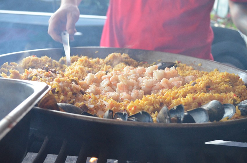 Vinnie Salvadel cooks seafood paella for the second dish.