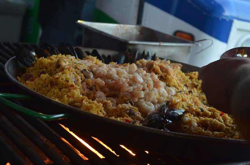 Vinnie Salvadel cooks seafood paella for the second dish.