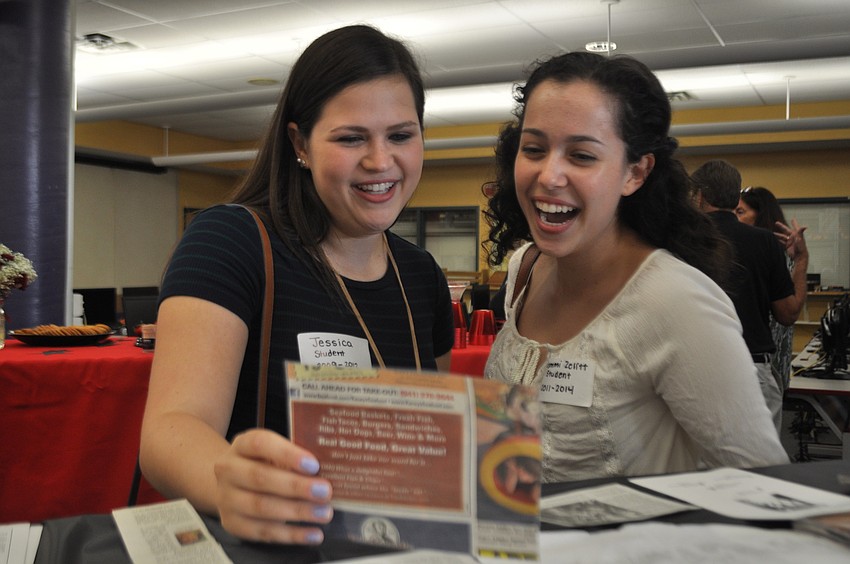 Former students and sisters Jessica and Sammi Zelitt look at an old news clip about their school.