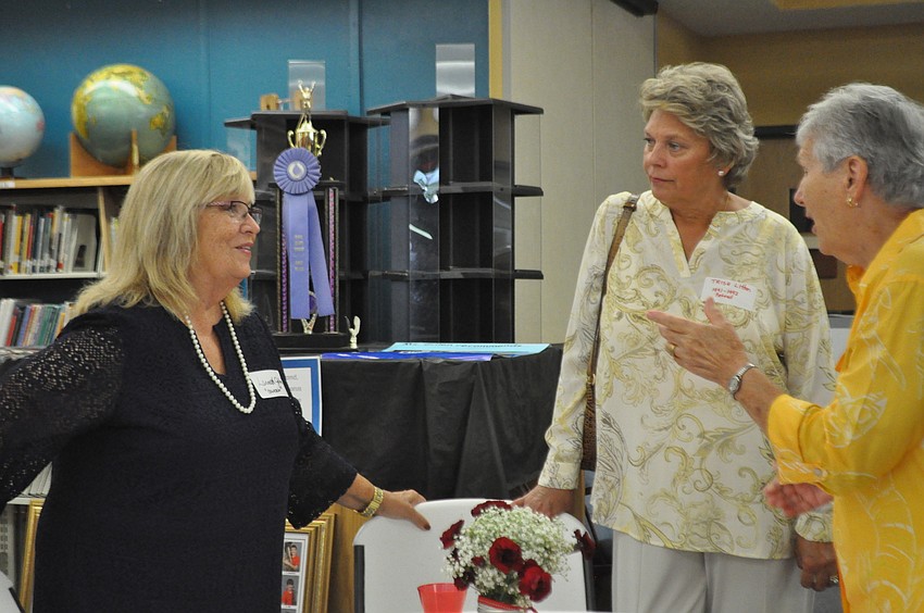 Retiring counselor Lannette Gillen talks with the first assistant principal, Trish Litton, and the first secretary, Cecilia Thomas.