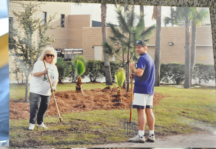 Guidance counselor Lannette Gillen and Rob Bacon, former literature teacher, help plant trees at the school in 1995.