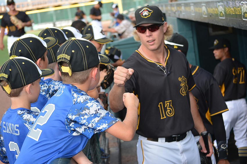 Manatee All-Star Cameron Yates gets a fist bump from Marauders outfielder Michael Suchy.