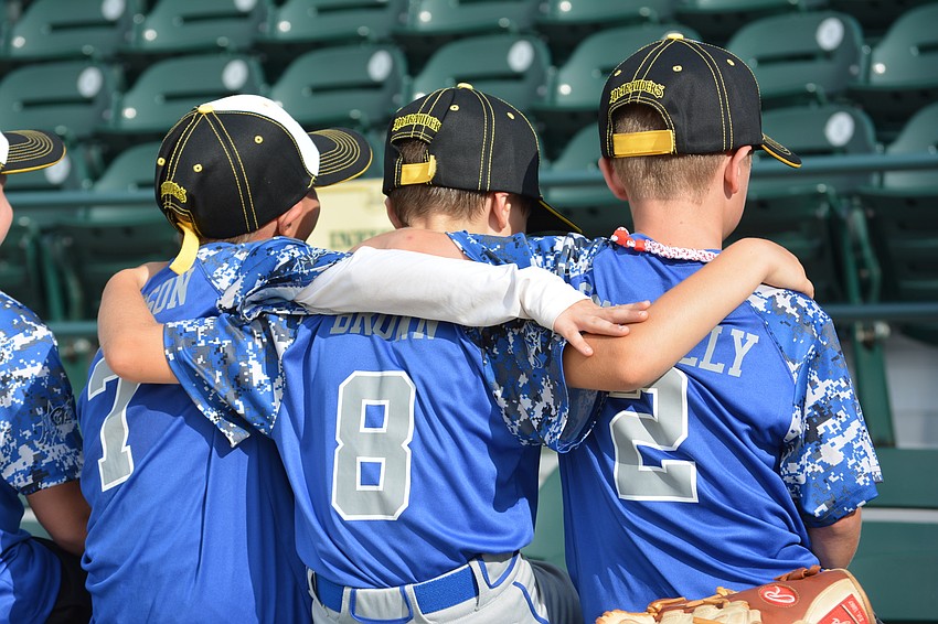 Benjamin Jameson, Tyler Brown and Tyler Connelly showed some team togetherness before the Marauders take the field.