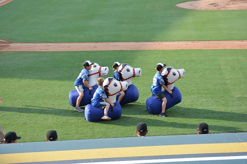 Brody Wells, Tyler Connelly, Tyler Brown and Cameron Yates compete in a bounce race between innings at McKechnie Field.