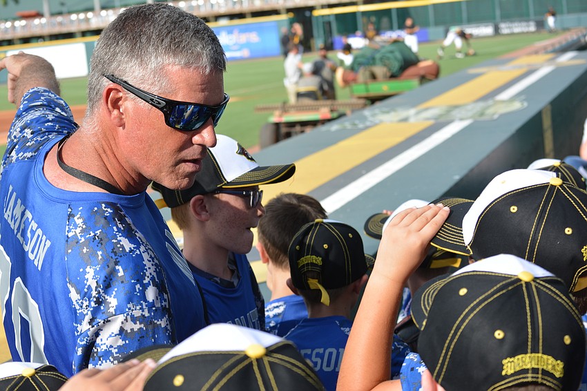 Robert Jameson, the 8U Manatee Cal Ripken All-Star team coach, gives his players instructions before the Marauders face the Tampa Yankees.