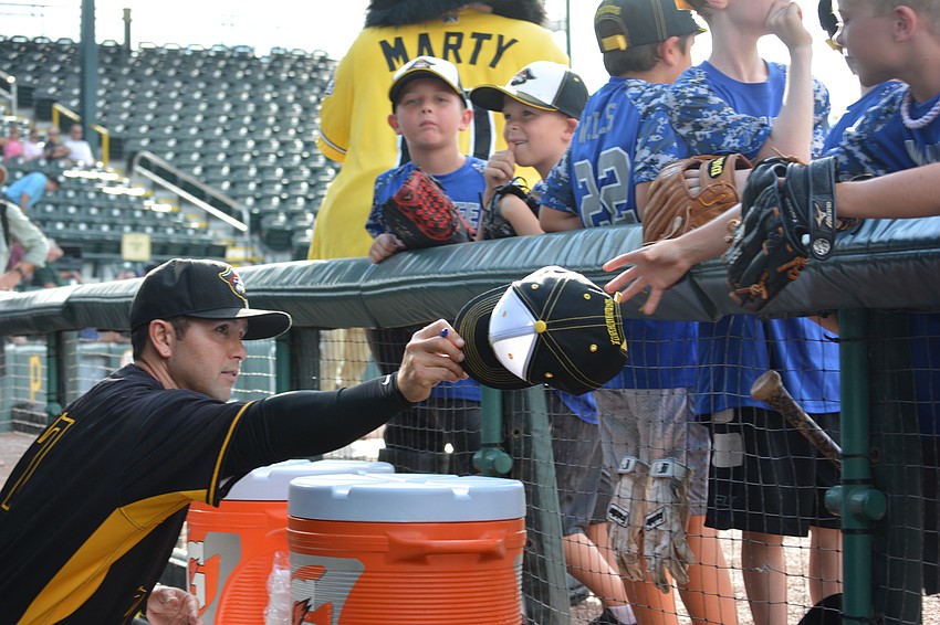 Marauders hitting coach Keoni De Renne gives the Manatee All-Stars lots of autographs.