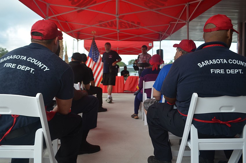 Sarasota firefighters John Chu (left) and Kevin Battle (right) wait for the grand opening festivities to begin at Sarasota's new Wawa location on Washington Boulevard Thursday, June 9.