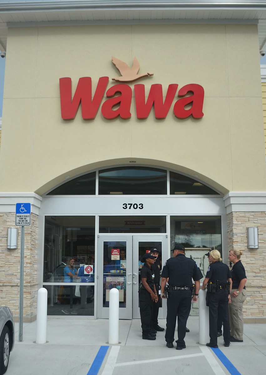 Sarasota Police Department members gather in front of Sarasota County's first Wawa location Thursday, June 9. The store plans to open several locations in the Sarasota area in the next five years.