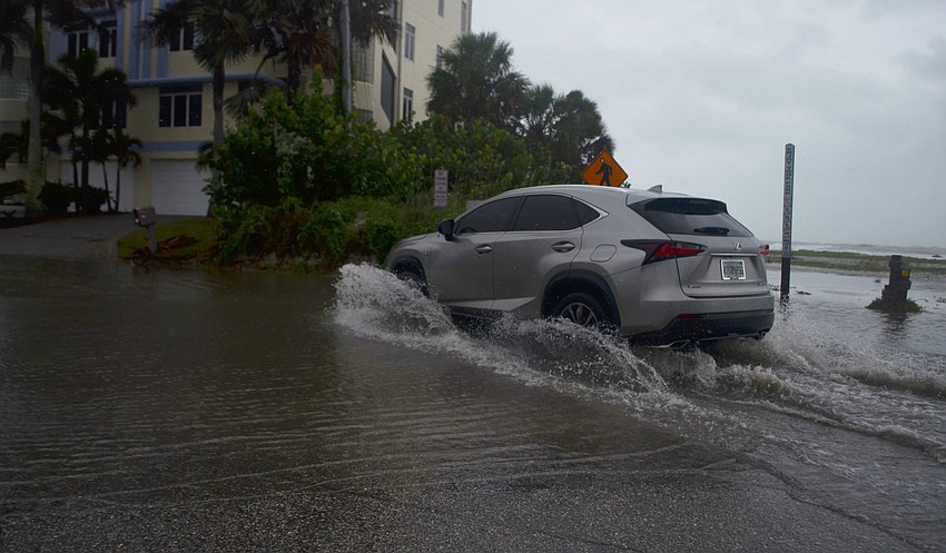 A car turns onto Beach Road from Columbus Boulevard on Siesta Key Monday, June 6. County officials closed Beach Road between Columbus Boulevard and Avenida Messina earlier that day due to flooding