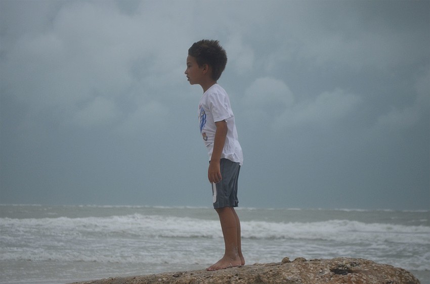 Carson Aker, 6, leans against the wind on the beach on Siesta Key, Monday, June 6. The National Weather Service predicted wind gusts up to 37 mph Monday afternoon.