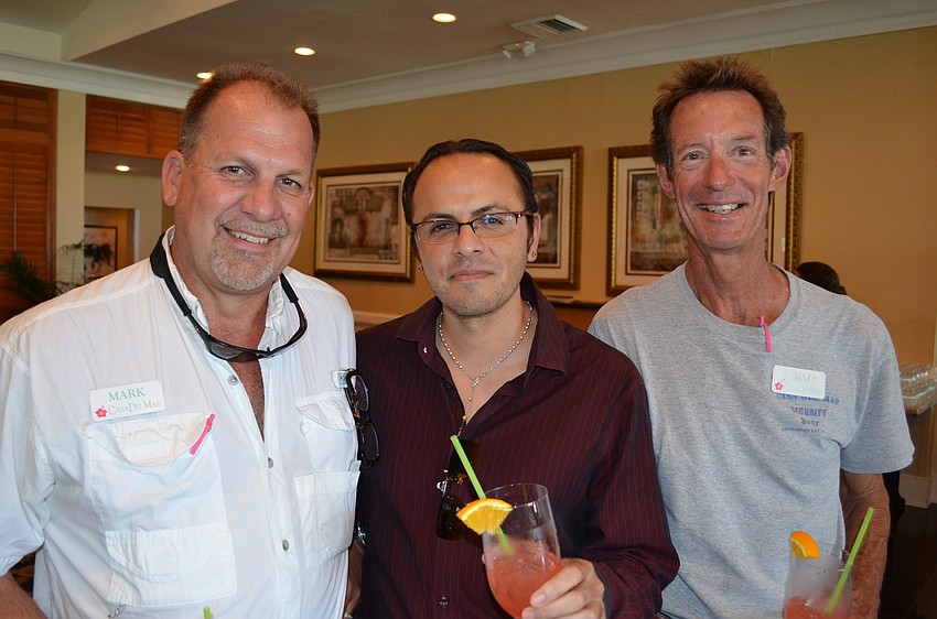 Mark Meador, Elton Arellano and Jim Gottschalk work at Casa Del Mar, which recently received new sand through the town’s truck haul.