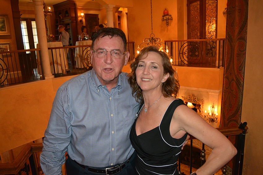 Lou Marinaccio gets a hug from The Players CEO Michelle Bianchi Pingel for hosting Friday night's fundraiser.