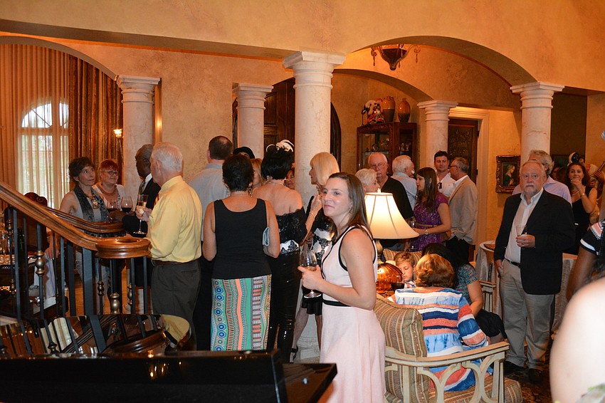 Guests mingle during a fundraiser for The Players Centre for the Performing Arts at Lou and Ann Marie Marinaccio's home in Lakewood Ranch.