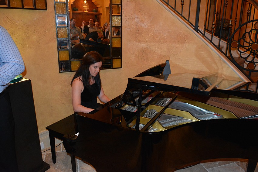 Rebecca Heintz, the music director for The Players Centre for the Performing Arts, entertains guests at Lou and Ann Marie Marinaccio's home in Lakewood Ranch.