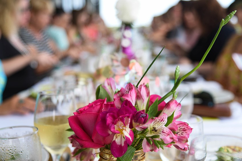 Nearly 40 guests gathered at a banquet table to enjoy a three-course gourmet brunch.