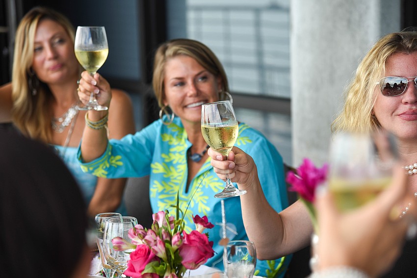 The guests raise a toast to friendship.