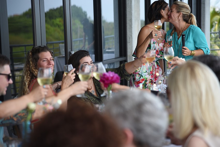 Co-Hosts Courtney Lauderdale and Nikki Logan-Curran raise a toast to friendship with the guests at the event.