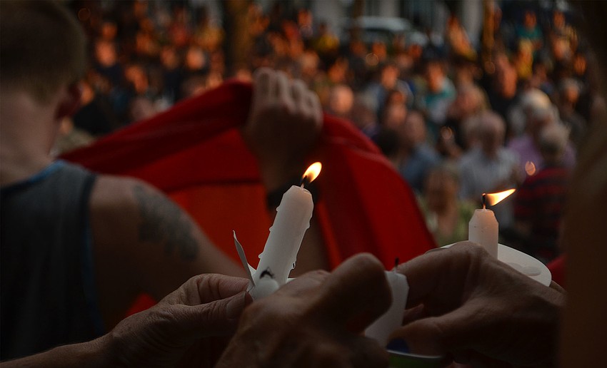 Candles were lit on behalf of the victims of the Pulse nightclub shooting at a vigil in Five Points Park in Sarasota Florida June 13, 2016.