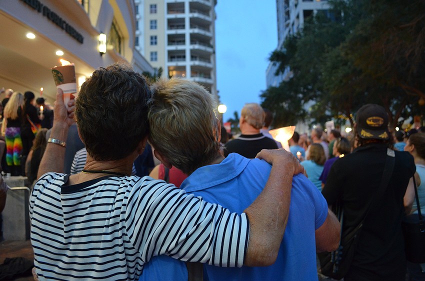 Susan DuPreue and Sandy Levesque embrace during the vigil.