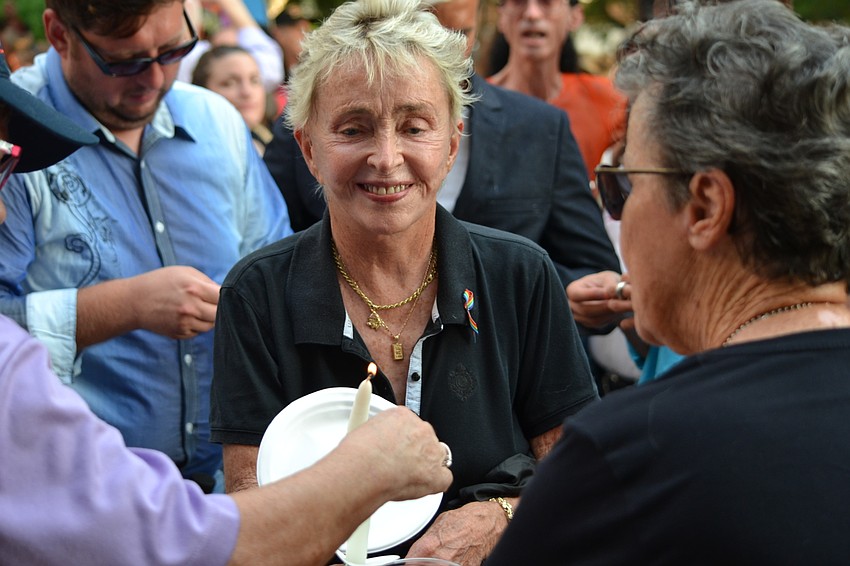 Paulina Tondreau helps light candles.