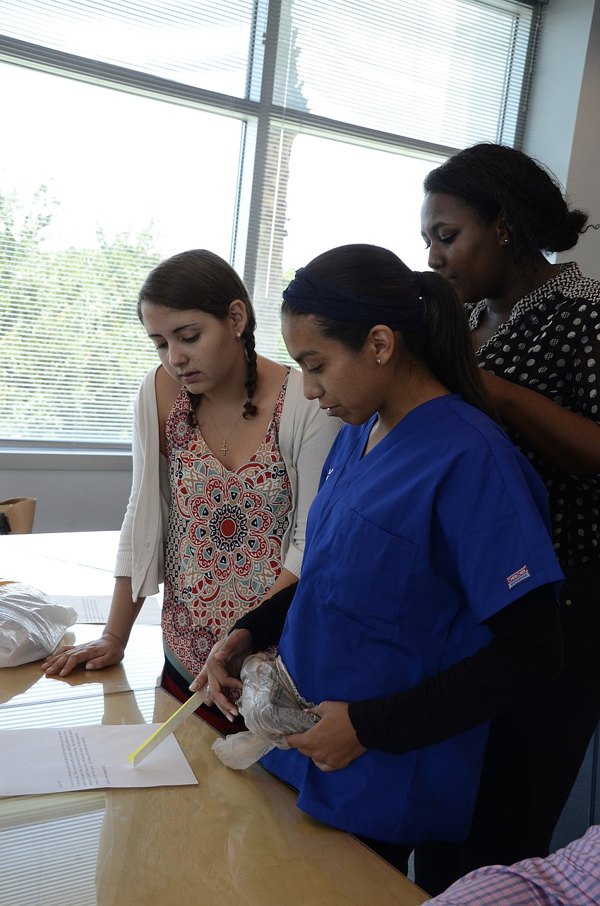 Arianna Murdocca of Venice High School, Alondra Hernandez of Manatee High School and Mayada Elshiek of Booker High School try to diagnose an ectopic pregnancy.