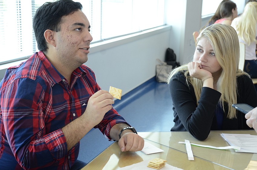 Heather Hall of the Manatee School of the Arts watches intently as Thomas Andre Waters tries to eat five Saltines in 60 seconds at the saliva lab.