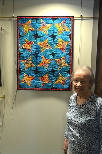 Cynda Grenfell, with "Stars 1," began quilting 12 years ago.