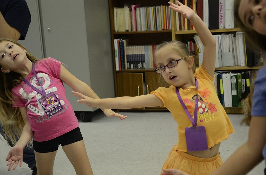 Avery Clough of McNeal Elementary and Madeline Freed of Wakeland Elementary practice a routine to 