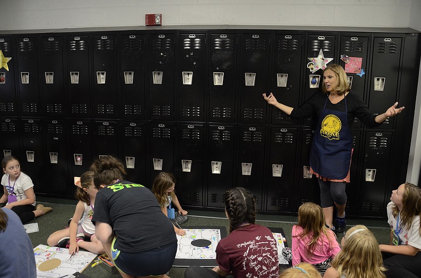 Camp art instructor Pat Ross talks to students about the importance of costumes in a production. During the school year, she teaches theater at Manatee School for the Arts.