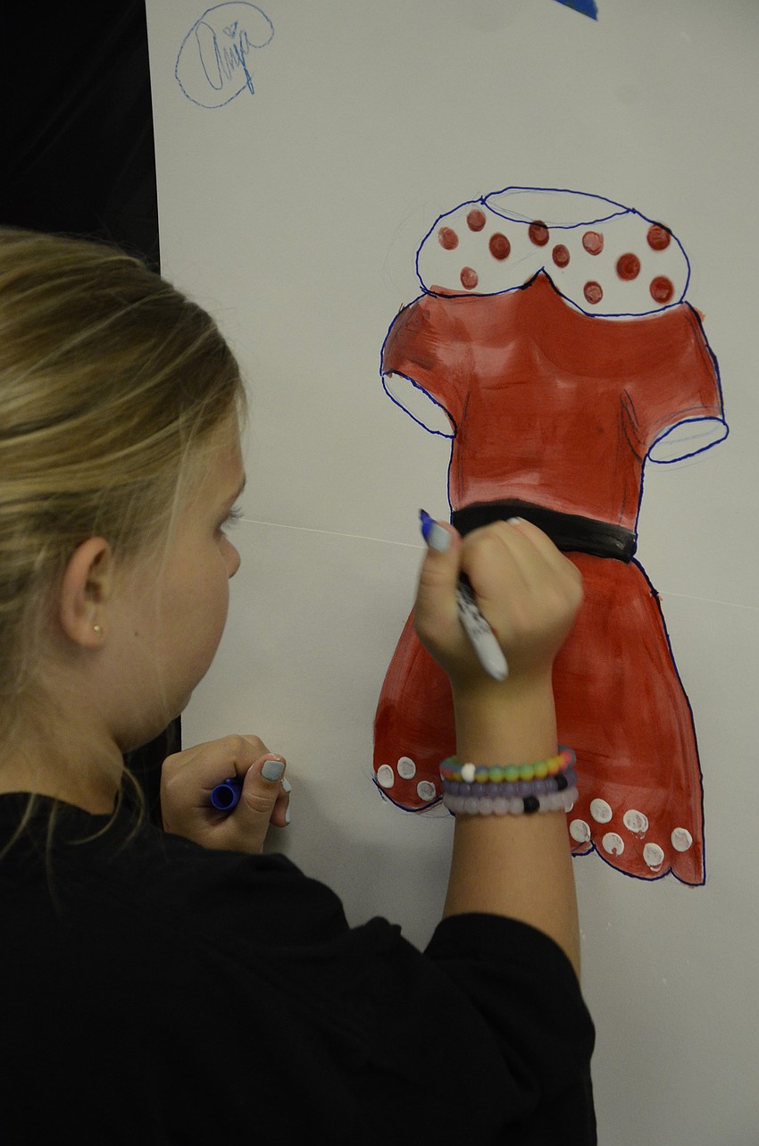 Anja Schwarzbauer of McNeal Elementary puts the finishing touches on her costume painting.