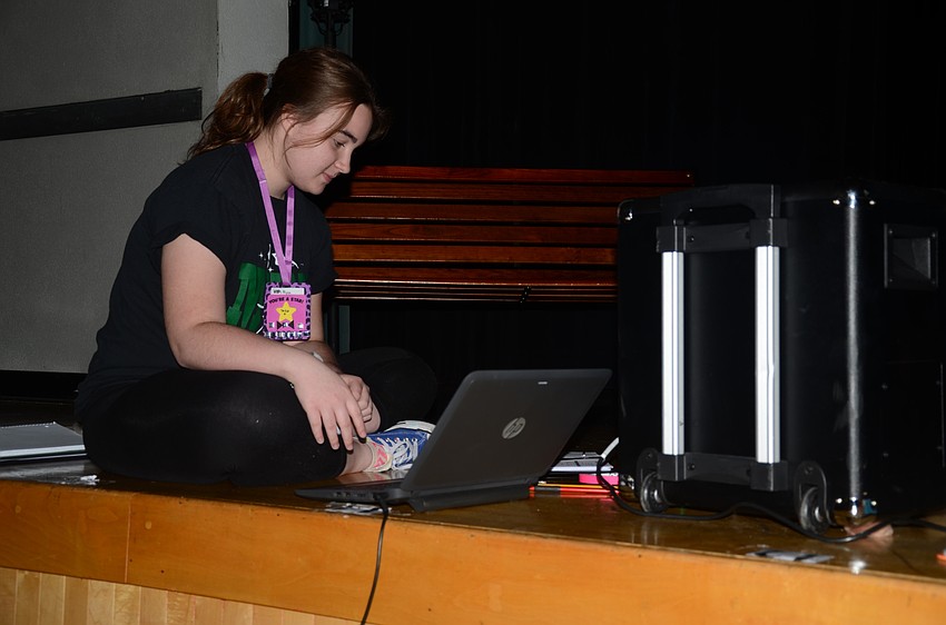 Camp counselor Alysa Ness of Lakewood Ranch High School helps out with music.