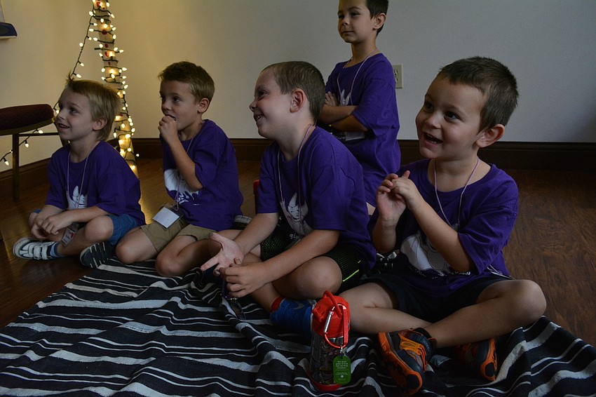 Brennon Soto, right, smiles as he learns a friend has the Holy Spirit. Also pictured from left to right are: Tyler Rindfleisch, Logan Cole and Noah Campbell.