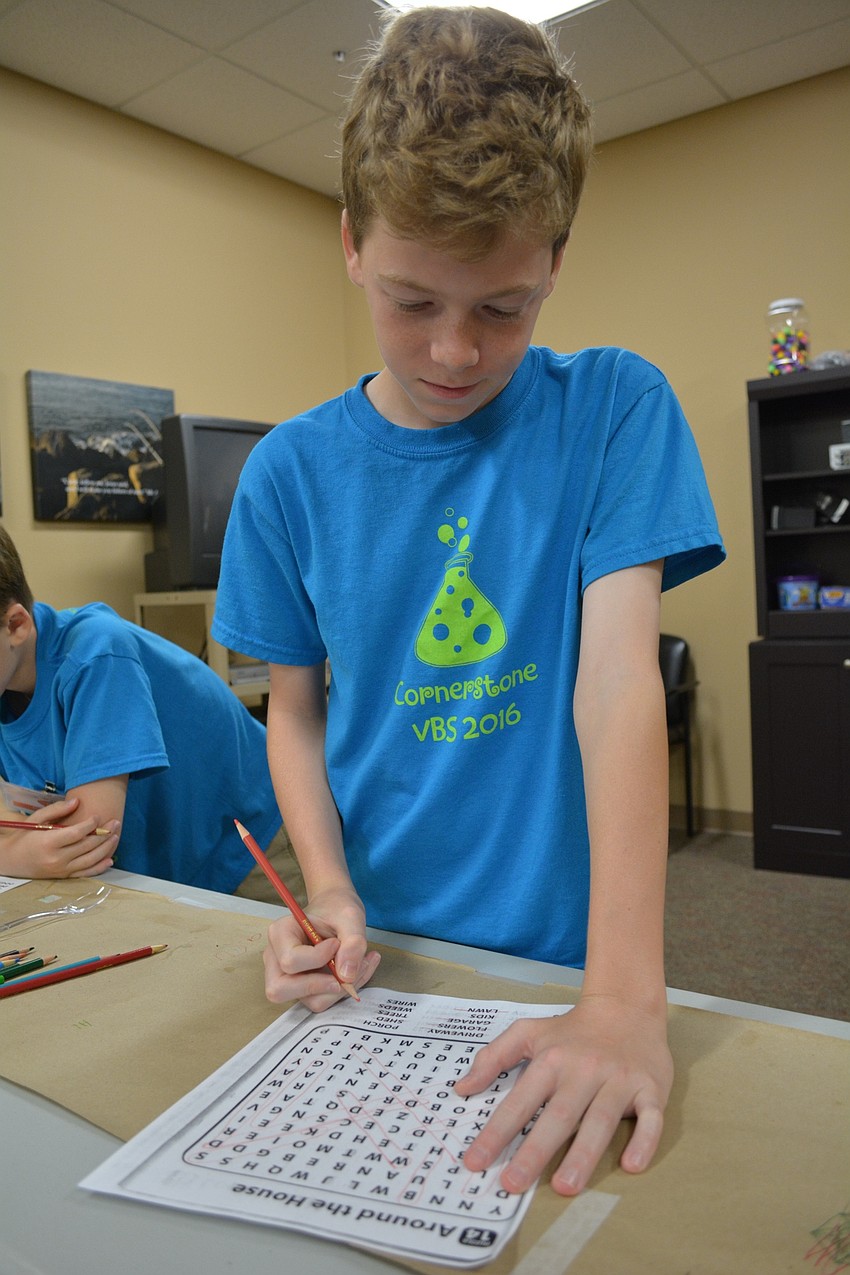 Andrew Brannon, 11, of GreyHawk Landing, completes a word search puzzle.