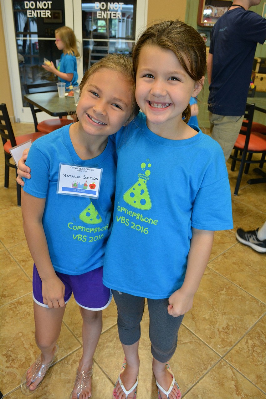 Natalie Shields, 6, and Emma Albert, 7, head in for snack time.