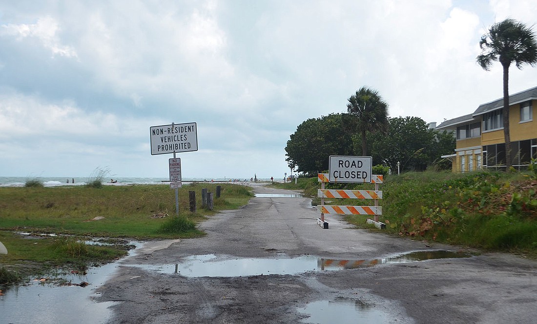 Signs prohibiting public vehicle access stand on either side of a portion of Beach Road that has inspired a lawsuit against the county.