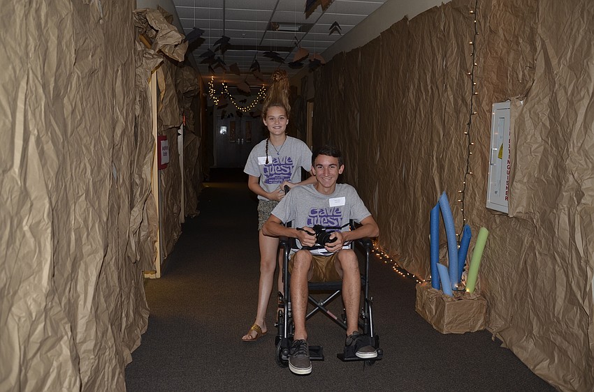Vacation Bible school leaders Lily Dunn and Jordan Conelias take a walk through the tunnels of Harvest United.