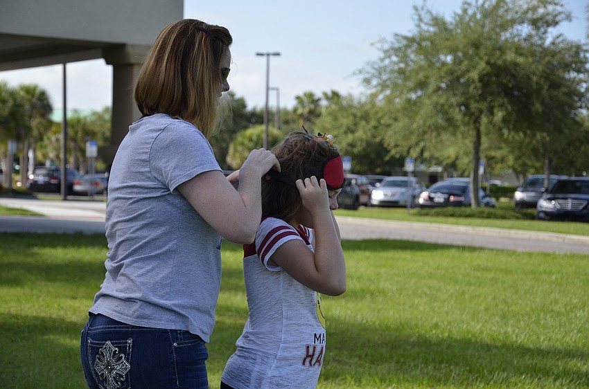 Kerri Martin helps her daughter, Delaney, navigate a path. 
