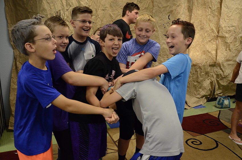 Trevor Schmid, Nicholas Almeida, Alex den Boggende, Jayden Halas, Gabriel Klein, Blake Boules, Garrett Day and Jacob Crum try to form a circle without letting go of each other's hands.