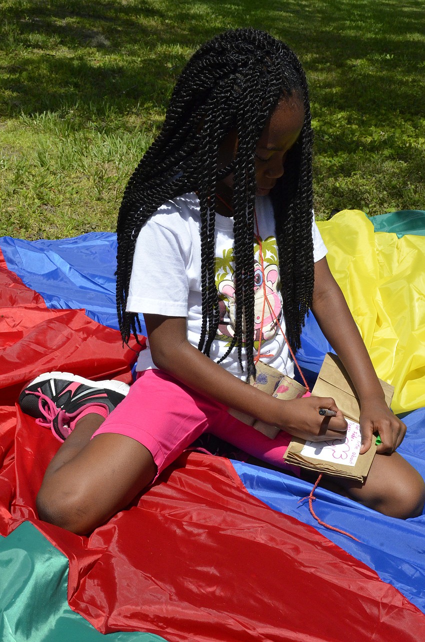 Blessing Ebai writes in her nature journal.