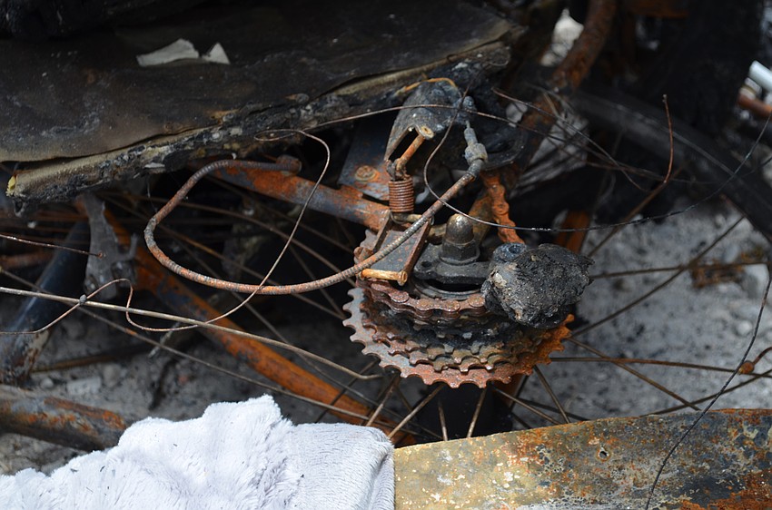 A rusted bicycle is indicative of the variety of items that were destroyed in the warehouse fire.