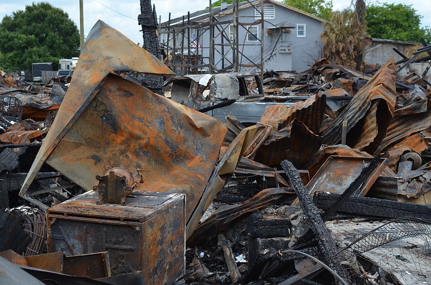 An antique press is among the rubble.