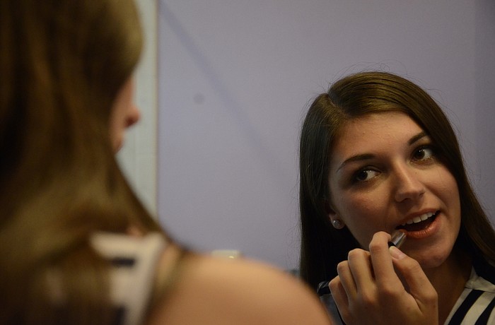 Samantha Hyatt touches up her lipstick.
