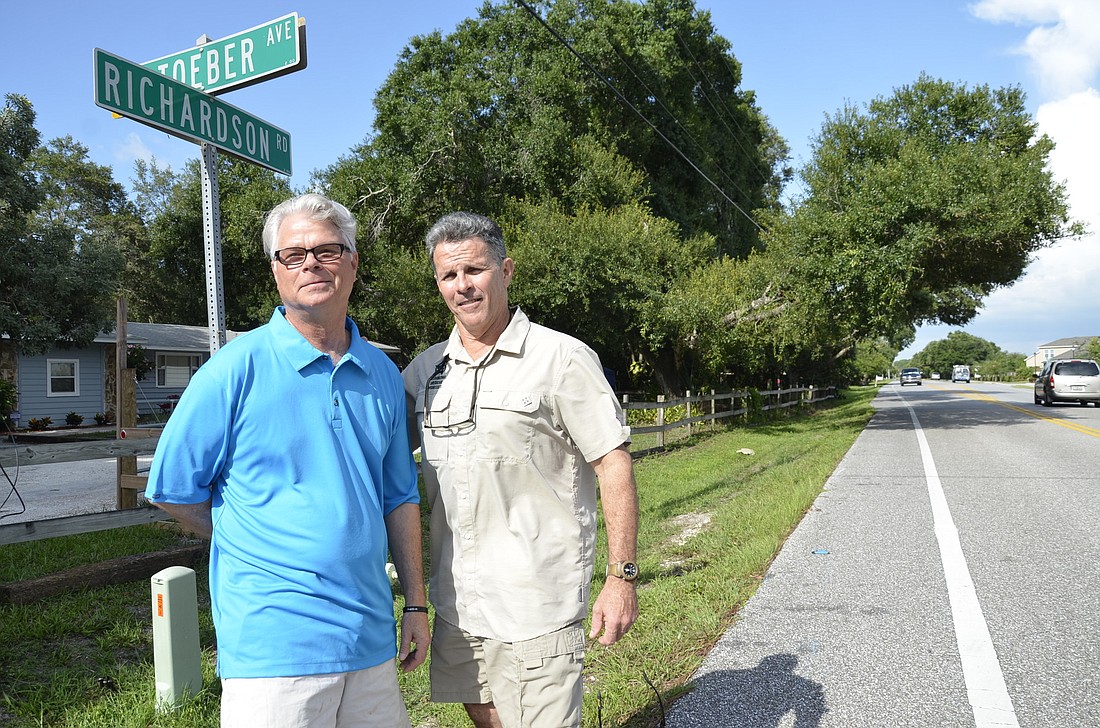 Gary Heffner and John Krotec stand on the street for which they've spent 11 years working with Sarasota County to get sidewalks and streetlights to get.