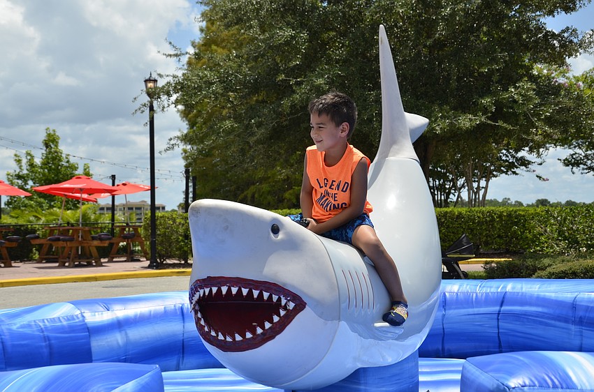 Ricardo Quintana of Sarasota rides the great white mechanical shark.
