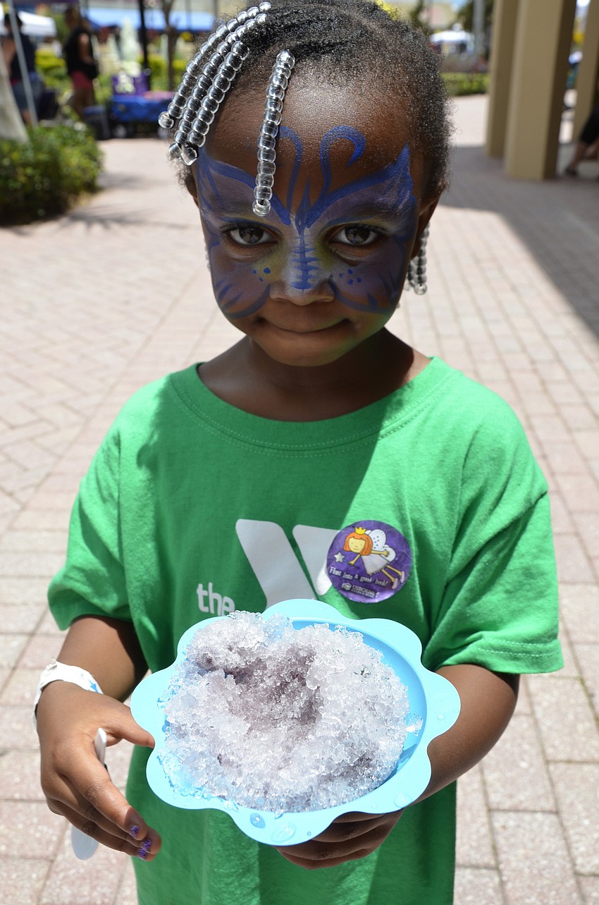 Undraya Eddins of Bradenton got a grape snow cone that matched her butterfly face paint.